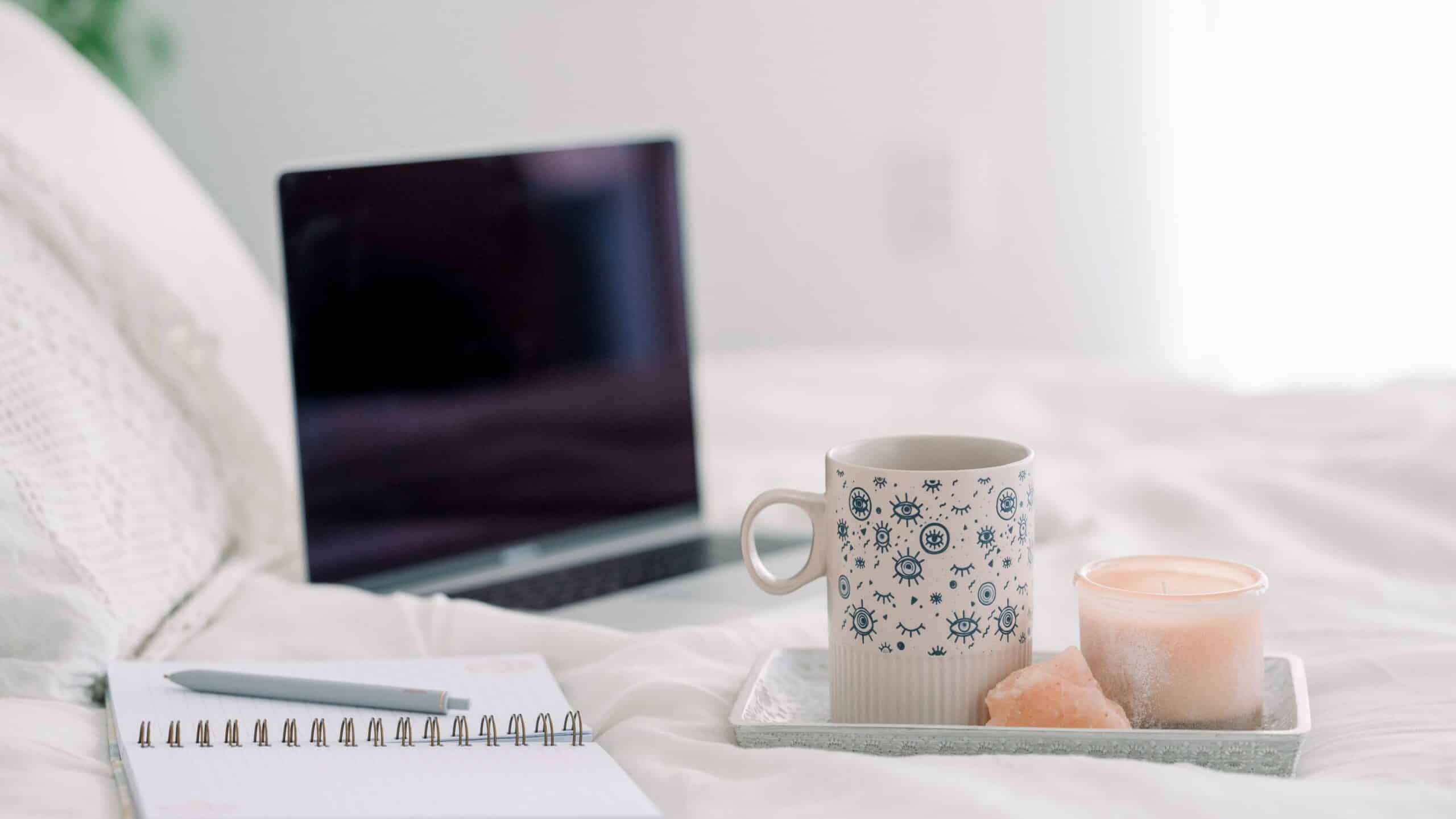 journaling, tea, and a candle - benefits of sleeping with crystals under your pillow
